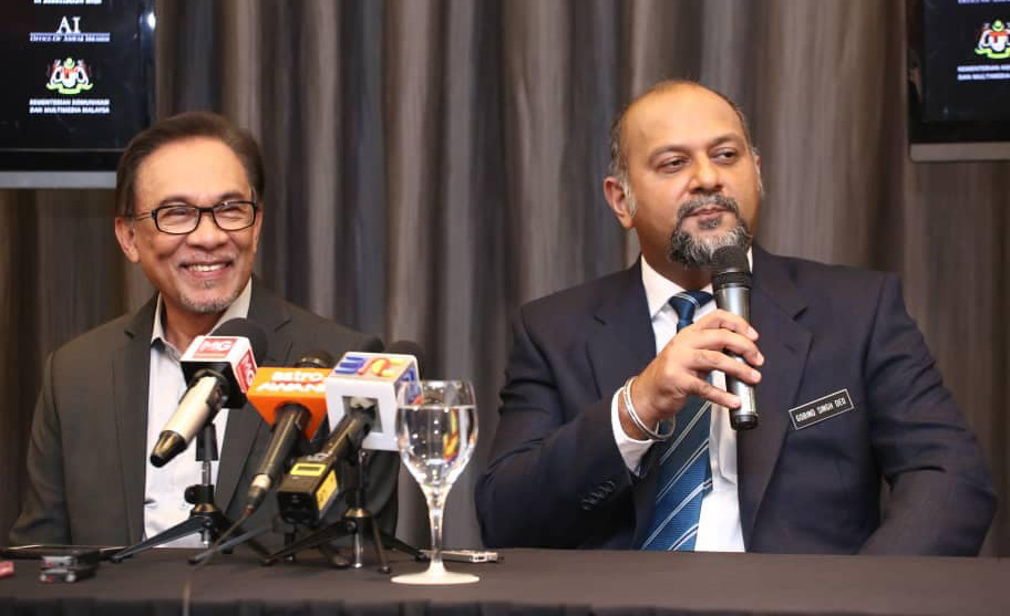 PKR president Anwar Ibrahim (left) with Communications and Multimedia Minister Gobind Singh Deo