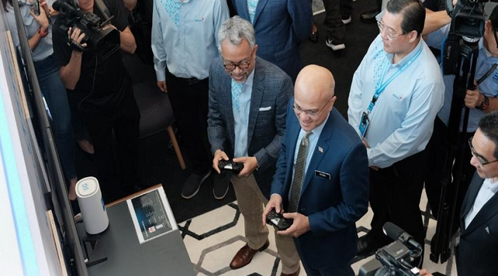 Celcom Axiata Bhd recently deployed Malaysia's first 5G Live Cluster Field Trial. Celcom CEO Idham Nawawi (left) is playing a video game over the 5G network with Malaysian Communications and Multimedia Chairman, Al-Ishsal Ishak.