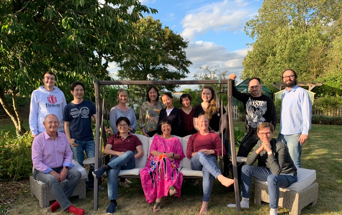 Cofounders, Paul Tasker (seated left) and Irene Ng (seated 3rd from left) with Dataswift personnel in the garden of their Cambridge-based office.
