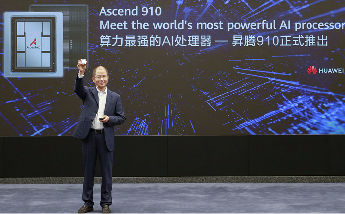 Huawei’s Rotating Chairman Eric Xu holding up its AI based chip.
