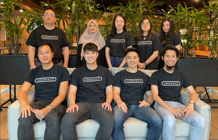 IIMMpact founders Alex Tan (seated 2nd left) and Alex Lee (seated 3rd left) with their team.