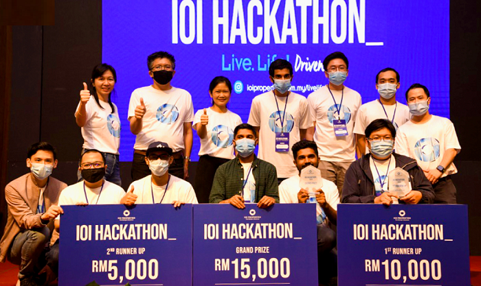 The top three teams pose with masks on (mostly) and thumbs up for the inaugural IOI Hackathon.