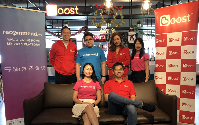 (Seated) Jes Min Lua, cofounder of Recommend Group and country GM for Malaysia with Mohd Khairil Abdullah, CEO of Boost with some of their team members.