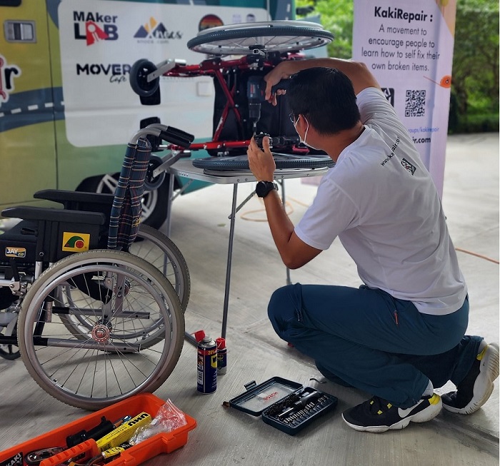 Johnson repairing a wheelchair as part of the Celebral Palsy group - Gaps Malaysia.