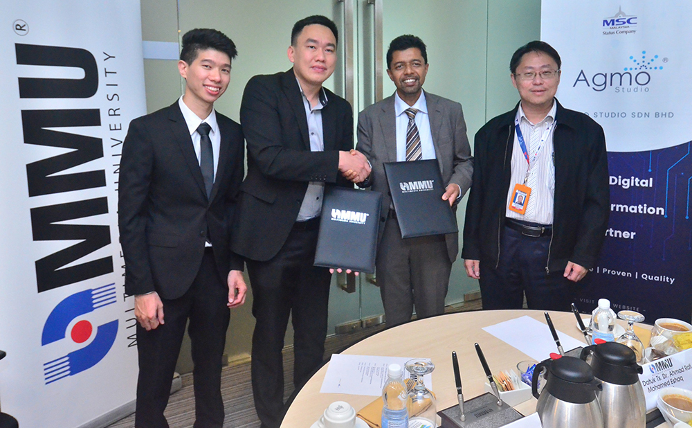 MMU president Prof Dr. Ahmad Rafi Mohamed Eshaq, (2nd right) exchanging MoU documents with Agmo Studio CEO Tan Aik Keong (2nd left) at MMU Cyberjaya. Prof Ho Chin Kuan, the Dean of Faculty of Computing Informatic (right) looks on.