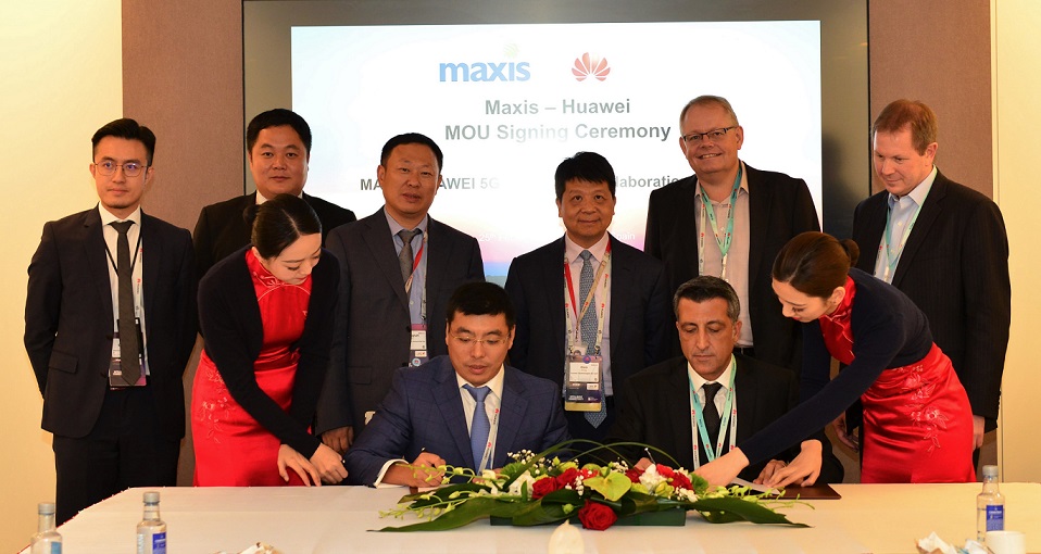 Maxis CEO-designate Gokhan Ogut (seated, right) and Huawei Malaysia CEO Michael Yuan sign the MoU