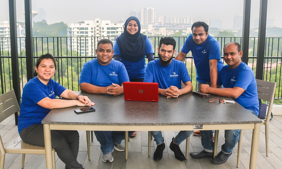 MyCash Online CEO Mehedi Hassan (sitting 2nd left) with his team 