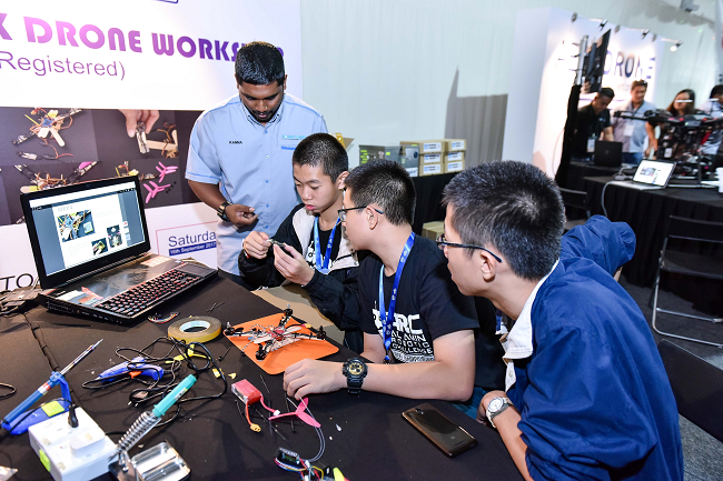 Students learning about drones at a MyDigitalMaker Fair in 2019.