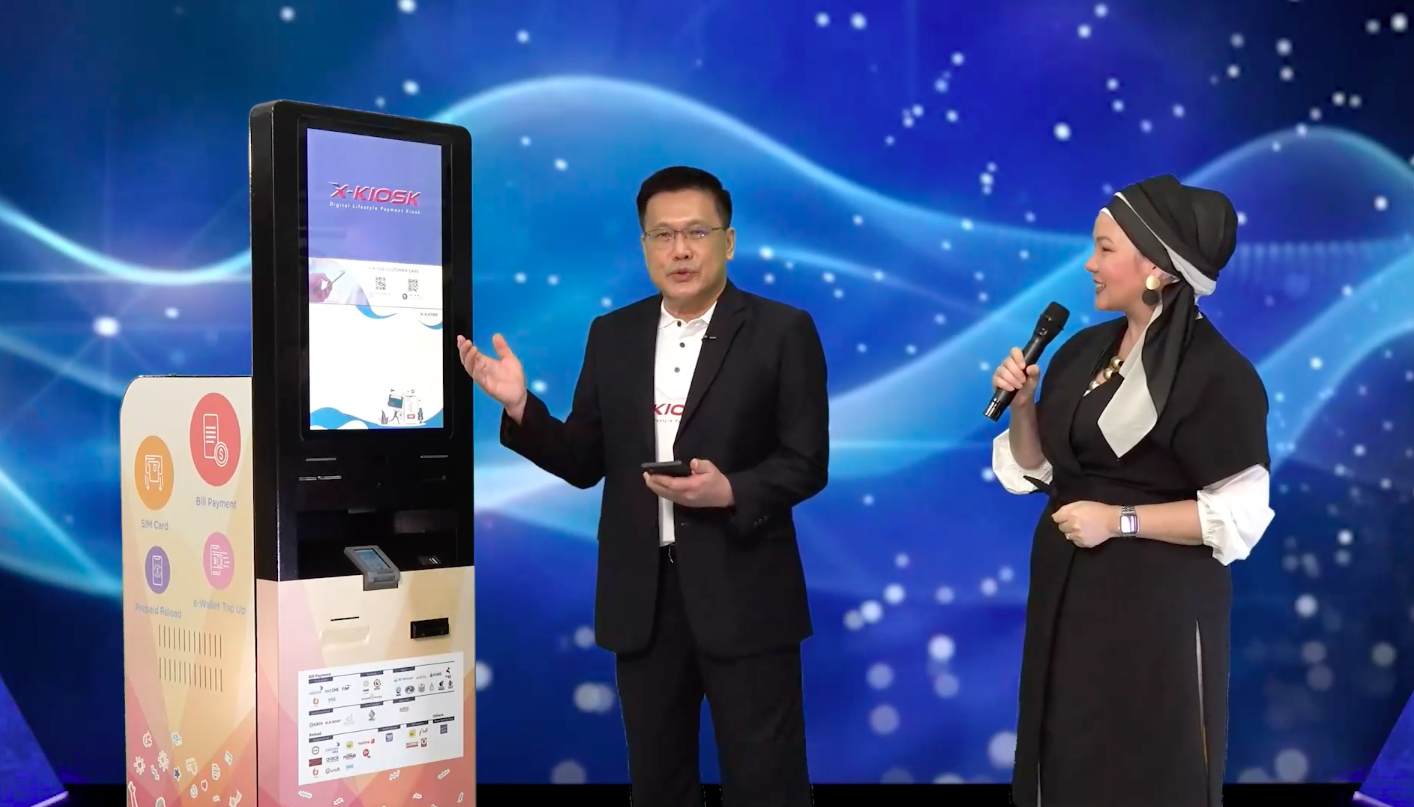 OpenSys CEO Eric Lim (Left) performing the first prepaid reload transaction with the Touch ‘n Go eWallet on the X-Kiosk