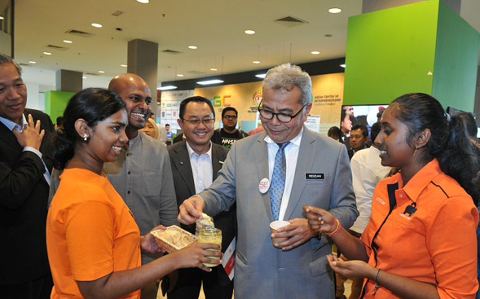 Malaysian MInister of Entrepreneur Development & Cooperatives, Redzuan Yusuf trying out the fare of a social enterprise at a Social Enterprise Accreditationevent held at MaGIC last year.